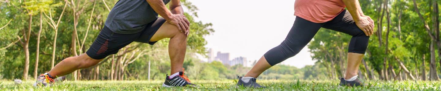 People stretching in park People stretching in park